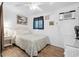 Bright bedroom with coastal decor, ceiling fan, and wood-look flooring at 5409 North Ocean Blvd. # 106/7108, North Myrtle Beach, SC 29582