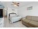 Bright bedroom with a bed, sofa, and neutral tile floors at 5409 North Ocean Blvd. # 106/7108, North Myrtle Beach, SC 29582