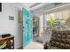 Inviting entrance featuring a bright turquoise door and a comfortable armchair at 5409 North Ocean Blvd. # 106/7108, North Myrtle Beach, SC 29582