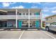 Two-story building exterior featuring parking spaces and charming blue doors at 5409 North Ocean Blvd. # 106/7108, North Myrtle Beach, SC 29582
