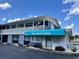 Two-story building exterior featuring a balcony, blue awning, and an American flag at 5409 North Ocean Blvd. # 106/7108, North Myrtle Beach, SC 29582