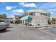 Two-story building exterior featuring a balcony, blue awning, and a parking area at 5409 North Ocean Blvd. # 106/7108, North Myrtle Beach, SC 29582