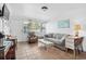 Inviting living room featuring tile flooring, comfortable seating, and bright natural light at 5409 North Ocean Blvd. # 106/7108, North Myrtle Beach, SC 29582