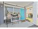 Cozy porch with seating, a table, and a charming blue door at 5409 North Ocean Blvd. # 106/7108, North Myrtle Beach, SC 29582