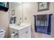 Cozy bathroom featuring a white vanity, framed mirror, and decorative starfish artwork at 5751 Oyster Catcher Dr. # 315, North Myrtle Beach, SC 29582