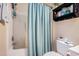 Full bathroom featuring a shower-tub combo with a blue curtain and a white toilet at 5751 Oyster Catcher Dr. # 315, North Myrtle Beach, SC 29582