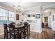 Cozy dining room with a wooden table, chandelier lighting, and a view into the kitchen area at 5751 Oyster Catcher Dr. # 315, North Myrtle Beach, SC 29582