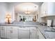 Open kitchen with white cabinetry, granite countertops, and seamless flow into the living area at 5751 Oyster Catcher Dr. # 315, North Myrtle Beach, SC 29582