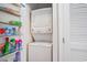 Efficient laundry area features a stacked washer and dryer, plus convenient shelving for supplies at 5751 Oyster Catcher Dr. # 315, North Myrtle Beach, SC 29582