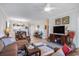 Bright living room that blends seamlessly with kitchen, featuring a cozy seating arrangement, television and stylish decor at 5751 Oyster Catcher Dr. # 315, North Myrtle Beach, SC 29582