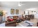 Well-decorated living room featuring a sectional sofa, recliner, ceiling fan, art, and wood-style floors at 5751 Oyster Catcher Dr. # 315, North Myrtle Beach, SC 29582