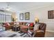 Comfortable living room featuring a large sectional sofa, leather recliner, ceiling fan, and natural light from a large window at 5751 Oyster Catcher Dr. # 315, North Myrtle Beach, SC 29582