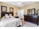 Comfortable main bedroom featuring a queen-size bed, dark wood furniture, neutral carpeting, and tasteful artwork at 5751 Oyster Catcher Dr. # 315, North Myrtle Beach, SC 29582