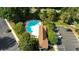 Aerial view showcasing the community pool, clubhouse, and ample parking surrounded by lush greenery and landscaping at 5825 Catalina Dr. # 124, North Myrtle Beach, SC 29582