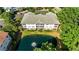 Aerial view of a condominium complex with a large pond surrounded by green trees at 5825 Catalina Dr. # 124, North Myrtle Beach, SC 29582