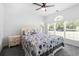 Bright bedroom with large window, ceiling fan, and comfortable king-sized bed at 5825 Catalina Dr. # 124, North Myrtle Beach, SC 29582