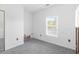 Carpeted bedroom with a window providing natural light at 5825 Catalina Dr. # 124, North Myrtle Beach, SC 29582