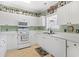 Charming kitchen with white cabinetry, modern appliances, and lots of decor at 5825 Catalina Dr. # 124, North Myrtle Beach, SC 29582