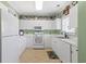 Bright kitchen boasts ample white cabinetry, modern appliances, and tiled floor at 5825 Catalina Dr. # 124, North Myrtle Beach, SC 29582