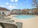Inviting community pool with plenty of lounge seating surrounded by well-manicured landscaping and community buildings at 5825 Catalina Dr. # 124, North Myrtle Beach, SC 29582