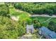 Aerial view of property bordering a golf course with lush green trees, adjacent to a parking lot at 598 Blue Stem Dr. # 52E, Pawleys Island, SC 29585