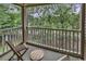 Relaxing balcony with two chairs and a table overlooking scenic views, perfect for enjoying the outdoors at 598 Blue Stem Dr. # 52E, Pawleys Island, SC 29585