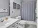 Bright bathroom featuring coastal decor, a white vanity, and a shower with a neutral shower curtain at 598 Blue Stem Dr. # 52E, Pawleys Island, SC 29585