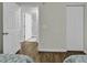 Spacious bedroom showcasing wood flooring, access to the en-suite bathroom, and a double-door closet at 598 Blue Stem Dr. # 52E, Pawleys Island, SC 29585