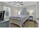 Bedroom featuring a ceiling fan, a nautical-themed bedspread, a sunny window, and an end table at 598 Blue Stem Dr. # 52E, Pawleys Island, SC 29585