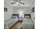 Charming bedroom with seashell-themed decor, twin beds, and a ceiling fan for a cozy retreat at 598 Blue Stem Dr. # 52E, Pawleys Island, SC 29585