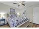 Inviting bedroom with a nautical themed quilt, complemented by a ceiling fan and a view into the en-suite bathroom at 598 Blue Stem Dr. # 52E, Pawleys Island, SC 29585