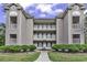 Three-story condo complex with beautiful balconies, green shutters and well-maintained landscaping at 598 Blue Stem Dr. # 52E, Pawleys Island, SC 29585