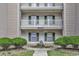 Close up exterior of condo with green shutters and landscaping, offering ground floor entrance at 598 Blue Stem Dr. # 52E, Pawleys Island, SC 29585