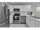 Bright white kitchen with stainless steel appliances and white countertops at 598 Blue Stem Dr. # 52E, Pawleys Island, SC 29585