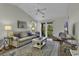 Relax in the bright living room with access to the private balcony at 598 Blue Stem Dr. # 52E, Pawleys Island, SC 29585