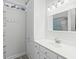 All-white bathroom featuring sleek vanity, fish decor, and walk-in shower at 6001 - 1737 S Kings Hwy., Myrtle Beach, SC 29575
