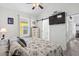 Bright bedroom featuring beach-themed decor, TV, a barn door to the ensuite, and natural light at 6001 - 1737 S Kings Hwy., Myrtle Beach, SC 29575