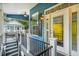 Blue coastal style home entryway, with side porch access, steps and black metal railings at 6001 - 1737 S Kings Hwy., Myrtle Beach, SC 29575