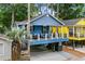 Charming blue beach house with a deck and lush landscaping at 6001 - 1737 S Kings Hwy., Myrtle Beach, SC 29575