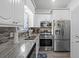 Well-equipped kitchen with stainless steel appliances and bright lighting at 6001 - 1737 S Kings Hwy., Myrtle Beach, SC 29575