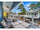 Comfortable porch view of outdoor seating area and neighborhood houses, and ceiling fans at 6001 - 1737 S Kings Hwy., Myrtle Beach, SC 29575
