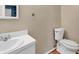 Cozy bathroom features a toilet and a sink with white cabinets, and warm paint color, providing a tranquil space at 633 Sparrow Dr. # B, Surfside Beach, SC 29575