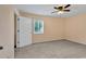 A neutral bedroom features plush carpet, a ceiling fan, a window, and a door to the rest of the house at 633 Sparrow Dr. # B, Surfside Beach, SC 29575