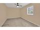This neutral bedroom is complete with a ceiling fan, plush carpet, a window, and relaxing paint colors at 633 Sparrow Dr. # B, Surfside Beach, SC 29575