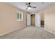 A comfortable bedroom includes soft carpeting, a ceiling fan, a window, and closet access for ample storage at 633 Sparrow Dr. # B, Surfside Beach, SC 29575