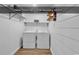 A laundry room with new flooring, washer, dryer, and shelf storage at 633 Sparrow Dr. # B, Surfside Beach, SC 29575