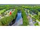A serene, eye-level view of the community featuring tree-lined streets and a large centrally located pond at 6420 Longwood Dr., Murrells Inlet, SC 29576