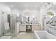 Bright bathroom with marble countertop, glass shower, chandelier, and bathtub at 6420 Longwood Dr., Murrells Inlet, SC 29576