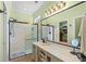 Light-green bathroom featuring a large mirror, and a glass enclosed walk-in shower at 6420 Longwood Dr., Murrells Inlet, SC 29576