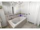 A bathroom featuring a luxurious soaking tub and modern fixtures and a chandelier at 6420 Longwood Dr., Murrells Inlet, SC 29576